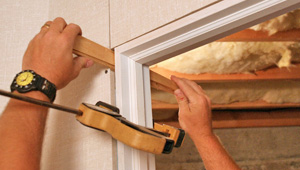 Installing trim and finishing touches to a remodeled basement in Waltham, MA