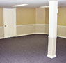 A water damaged finished basement repaired with our drywall repair system in Lawrence