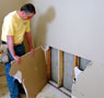 Water damaged drywall removal in progress in Lynn.