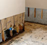Water damaged drywall with the wood studs, insulation, and drywall cut away in a home in Cambridge.